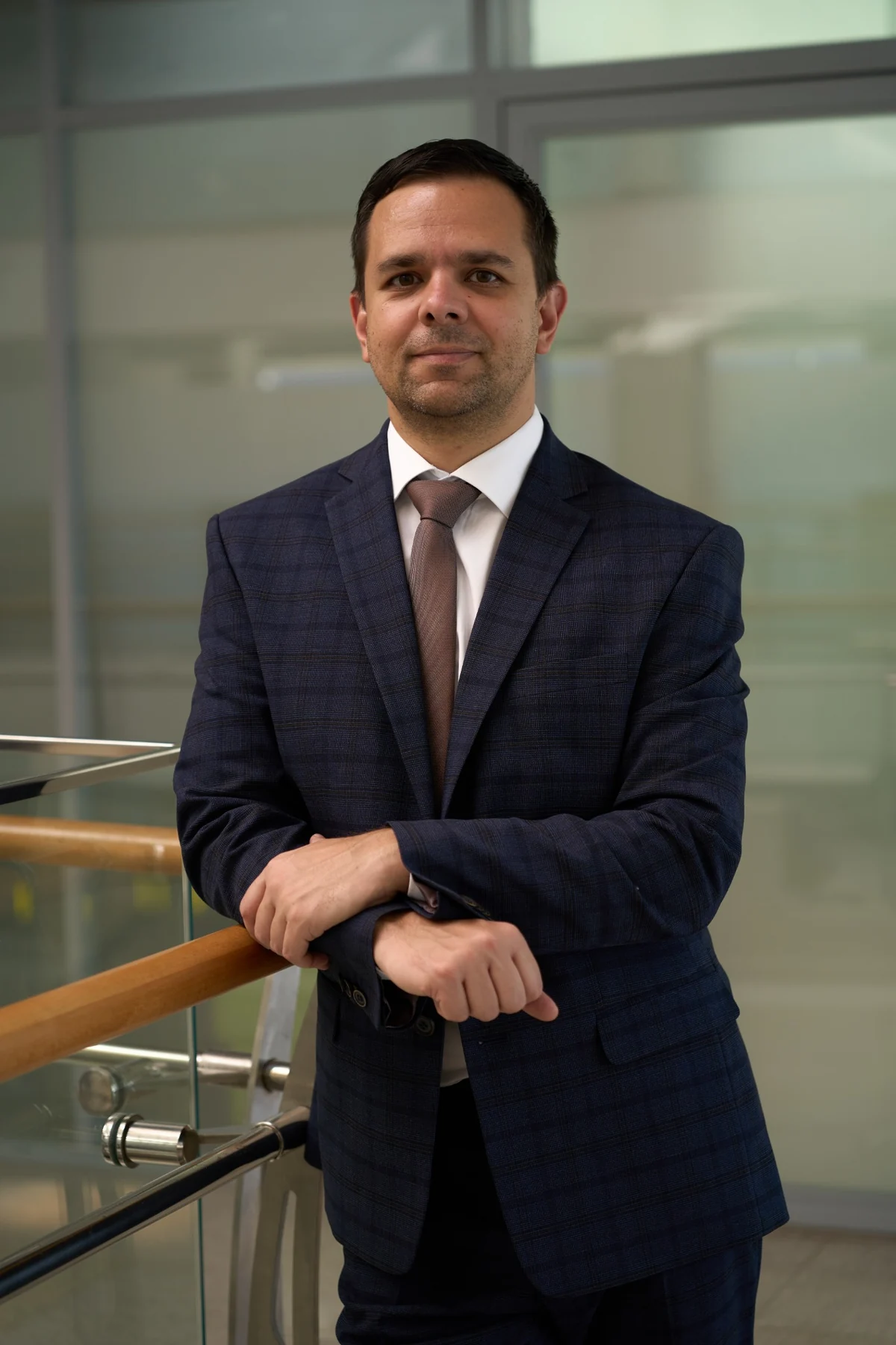 Lawyer in a business suit by a railing